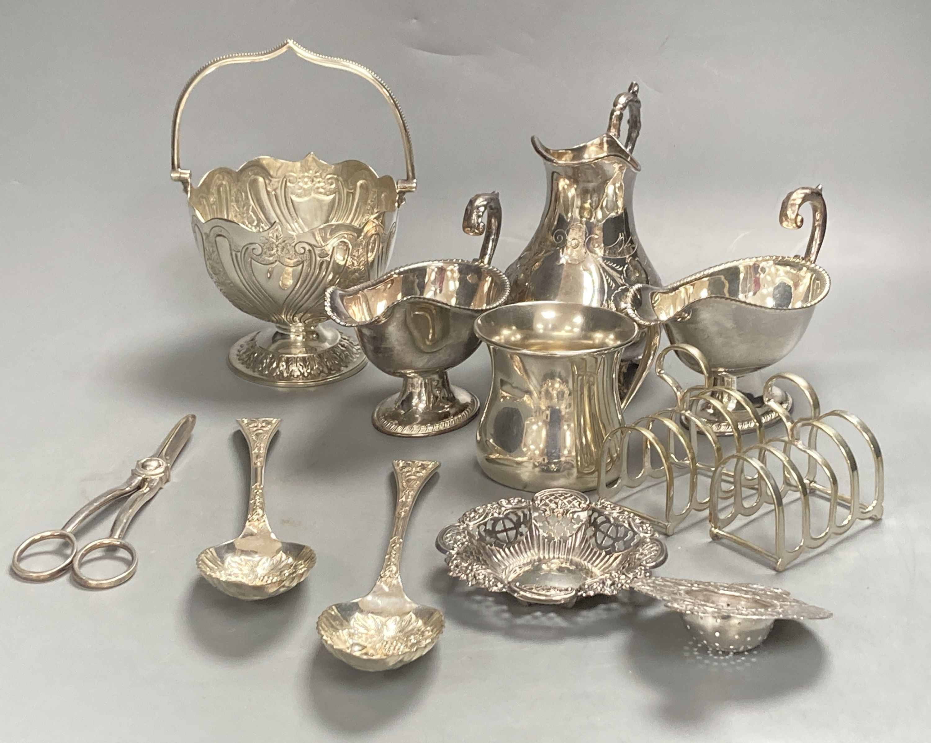 A sterling mug, a silver bonbon dish, a white metal strainer and a group of minor plated items.